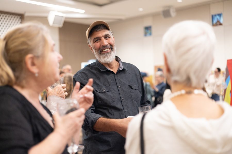 An artist chatting with guests
